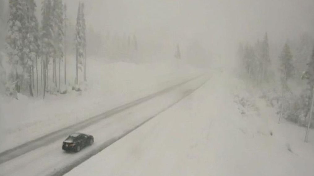 FILE PHOTO: Car drives on snowy Donner Pass in October 2021.{p}{/p}