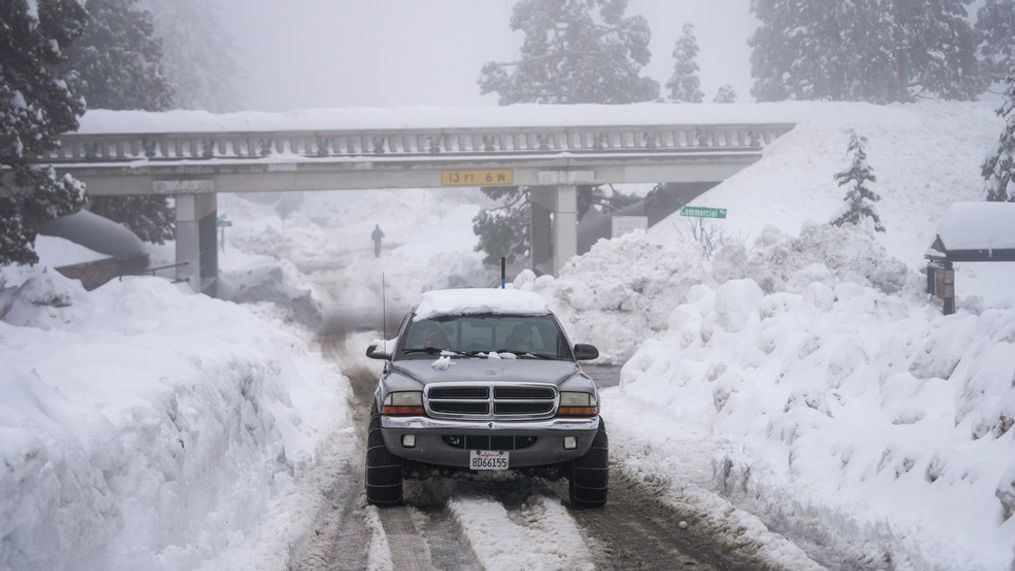 FILE - A truck drives along snow berms in Running Springs, Calif., Tuesday, Feb. 28, 2023. Since December, 2022, a parade of a dozen atmospheric storms have dumped so much snow up and down the Sierra that several ski resorts around Lake Tahoe have had to shut down multiple times. The National Weather Service in Reno recently called it the "winter that just doesn't want to end." (AP Photo/Jae C. Hong, File)